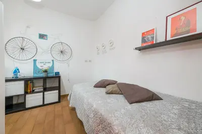 a bedroom with a bed and a bike on the wall at Mondrian House in Rome