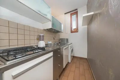 a small kitchen with a stove and a sink at Mondrian House in Rome