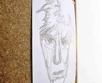 a drawing of a mans face on a sheet of paper at Mondrian House in Rome
