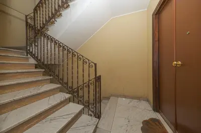 a staircase in a house with a wooden door at Mondrian House in Rome