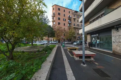 a street in a city with parked cars and buildings at Mondrian House in Rome