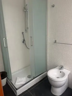 a bathroom with a shower and a toilet and a sink at Liberty Vatican Suites - Liberty Collection in Rome