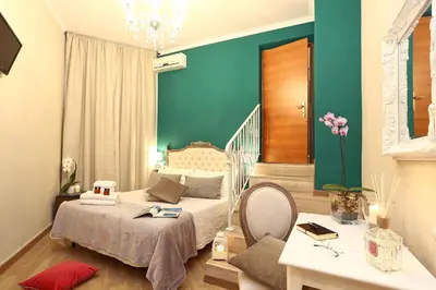 a bedroom with a bed and a blue wall at Liberty Vatican Suites - Liberty Collection in Rome