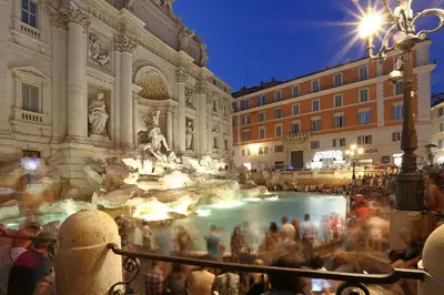 a crowd of people standing around a fountain in a city at Liberty Vatican Suites - Liberty Collection in Rome