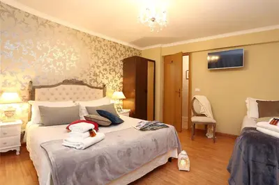 a bedroom with a bed with towels on it at Liberty Vatican Suites - Liberty Collection in Rome