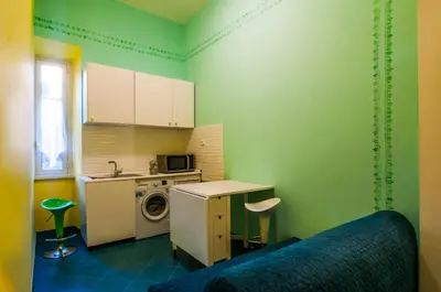 a green kitchen with a washing machine and a sink at Rome Best Rent in Rome