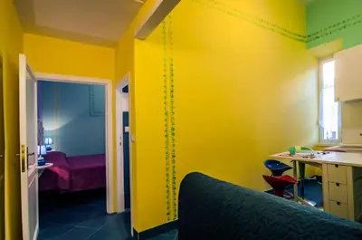 a yellow room with a room with a bed and a desk at Rome Best Rent in Rome