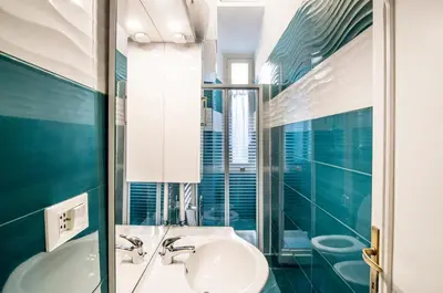 a bathroom with a sink and a mirror at Rome Best Rent in Rome