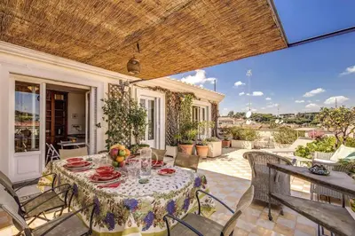 an outdoor patio with a table and chairs at Attic with Terrace Overlooking St Peter's Basilica in Rome