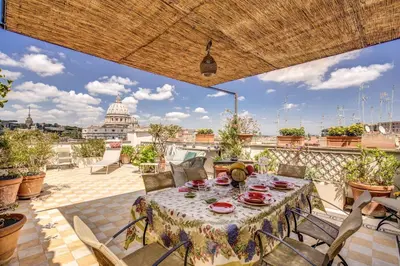 a table on a patio with a view of the capitol building at Attic with Terrace Overlooking St Peter's Basilica in Rome