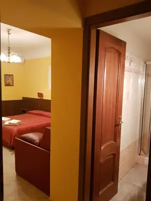 a door leading to a bedroom with a bed at B&B Rudy in Rome