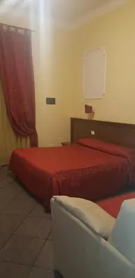 a hotel room with two beds and a couch at B&B Rudy in Rome
