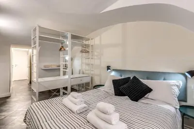 a bedroom with a bed with towels on it at Fori Imperiali Apartment in Rome