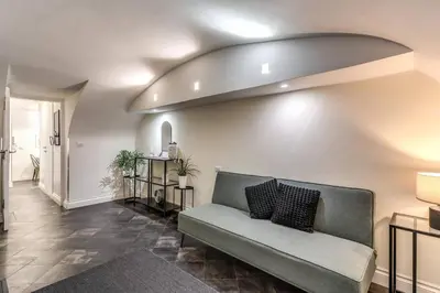 a living room with a couch against a wall at Fori Imperiali Apartment in Rome