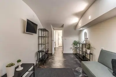 a living room with a couch and some plants at Fori Imperiali Apartment in Rome