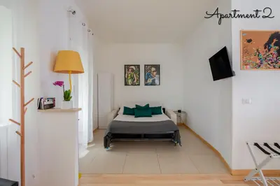 a bedroom with a bed with green pillows at PennyLane Rome Apartment in Rome