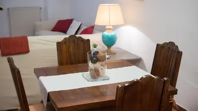 a table with chairs and a vase on top of it at Rental in Rome Panieri Terrace in Rome