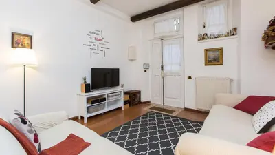 a living room with a white couch and a tv at Rental in Rome Panieri Terrace in Rome