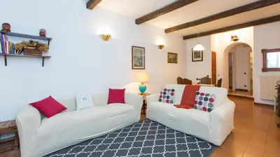 a living room with two white couches and a rug at Rental in Rome Panieri Terrace in Rome