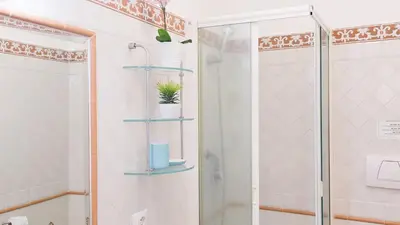 a bathroom with a shower with a glass shower backdoor at Rental in Rome Panieri Terrace in Rome
