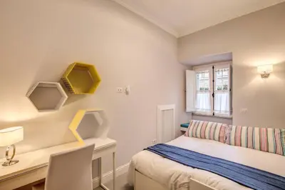 a bedroom with a bed and a desk and a window at Flat with terrace by Vatican in Rome