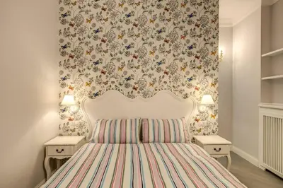 a bedroom with a white bed with a striped bedspread at Flat with terrace by Vatican in Rome
