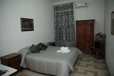 a bedroom with a bed with two stuffed animals on it at B&B Bel Ami in Rome