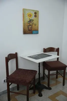 a table with two chairs and a picture on the wall at B&B Bel Ami in Rome