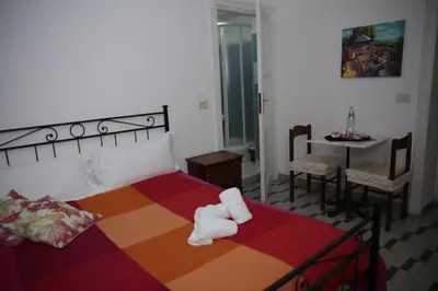 a bedroom with a bed and a table with a chair at B&B Bel Ami in Rome