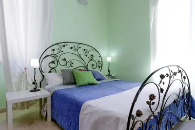 a bedroom with a bed with a blue comforter at Vintage 4 Bedrooms 20' Colosseum in Rome