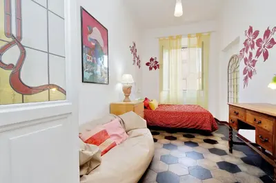 a living room with a couch and a bed at Vintage 4 Bedrooms 20' Colosseum in Rome