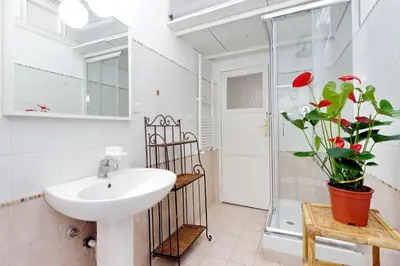 a bathroom with a sink and a mirror at Vintage 4 Bedrooms 20' Colosseum in Rome