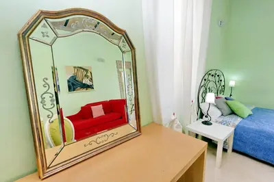 a mirror sitting on a table in a bedroom at Vintage 4 Bedrooms 20' Colosseum in Rome