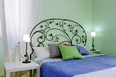 a bed with a large headboard in a bedroom at Vintage 4 Bedrooms 20' Colosseum in Rome