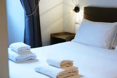 a hotel room with a bed with towels on it at THE ROMAN WAY San Giovanni in Rome