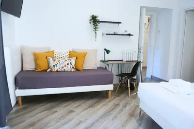 a bedroom with a bed with yellow pillows and a desk at THE ROMAN WAY San Giovanni in Rome