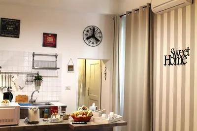 a kitchen with a sink and a clock on the wall at 50 Passi Colosseo Apartment in Rome