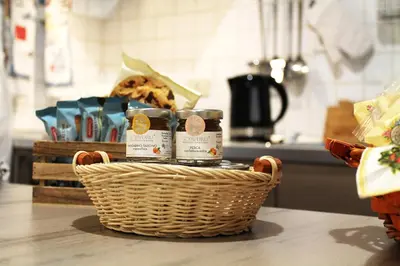 a basket of food on a table in a kitchen at 50 Passi Colosseo Apartment in Rome