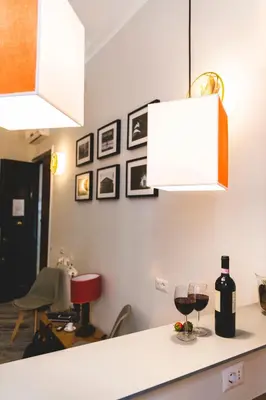 a kitchen with a counter with a glass of wine at Eccelso Hotel in Rome