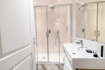 a bathroom with a shower and a sink at Eccelso Hotel in Rome