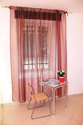a table and a chair in front of a window at Tra Gianicolo e Trastevere in Rome