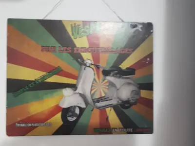 a poster of a scooter on a wall at Tra Gianicolo e Trastevere in Rome