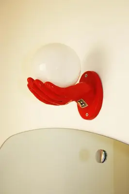a red bird light on the ceiling of a toilet at Tra Gianicolo e Trastevere in Rome