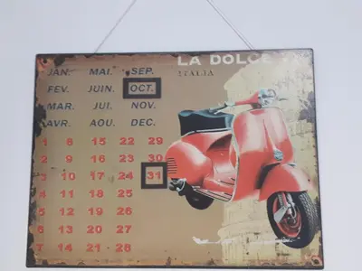 a calendar with a red scooter on it at Tra Gianicolo e Trastevere in Rome