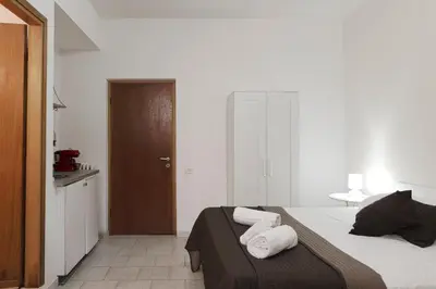 a bedroom with a bed with towels on it at Al Colosseo 8 in Rome