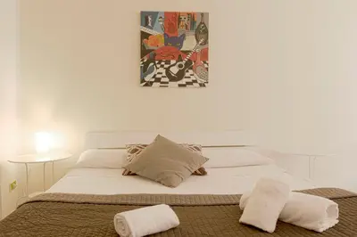 a bedroom with a bed with two towels on it at Al Colosseo 8 in Rome