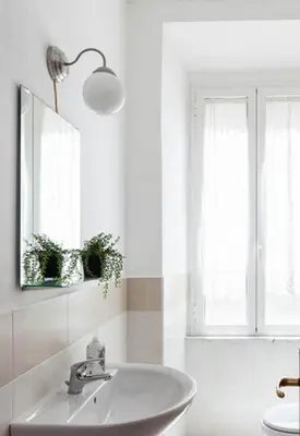 a white bathroom with a sink and a mirror at Al Colosseo 8 in Rome