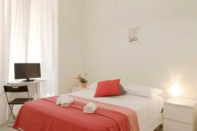 a bedroom with a bed with two towels on it at Al Colosseo 8 in Rome