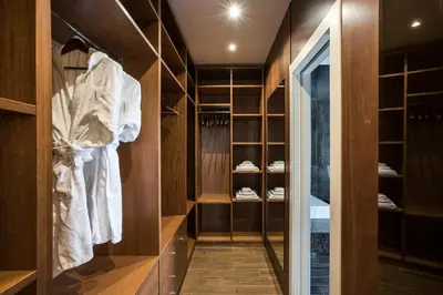 a walk in closet with wooden walls and shelves at Alta Luxury Apartments - Oca Apartment in Rome