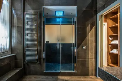 a shower with a glass door in a bathroom at Alta Luxury Apartments - Oca Apartment in Rome